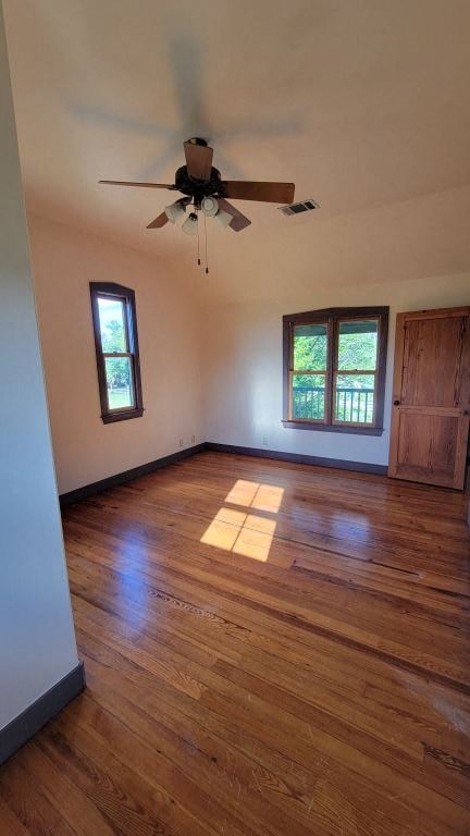 a empty living room with a ceiling fan