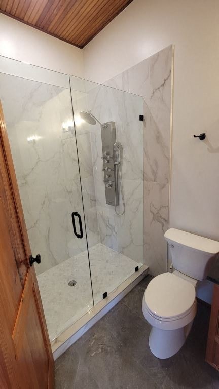 a bathroom with a toilet and a shower