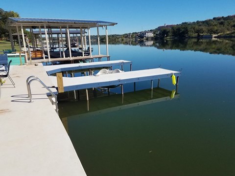 a dock with two benches on the water