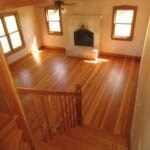 a living room with a wooden floor and a fireplace