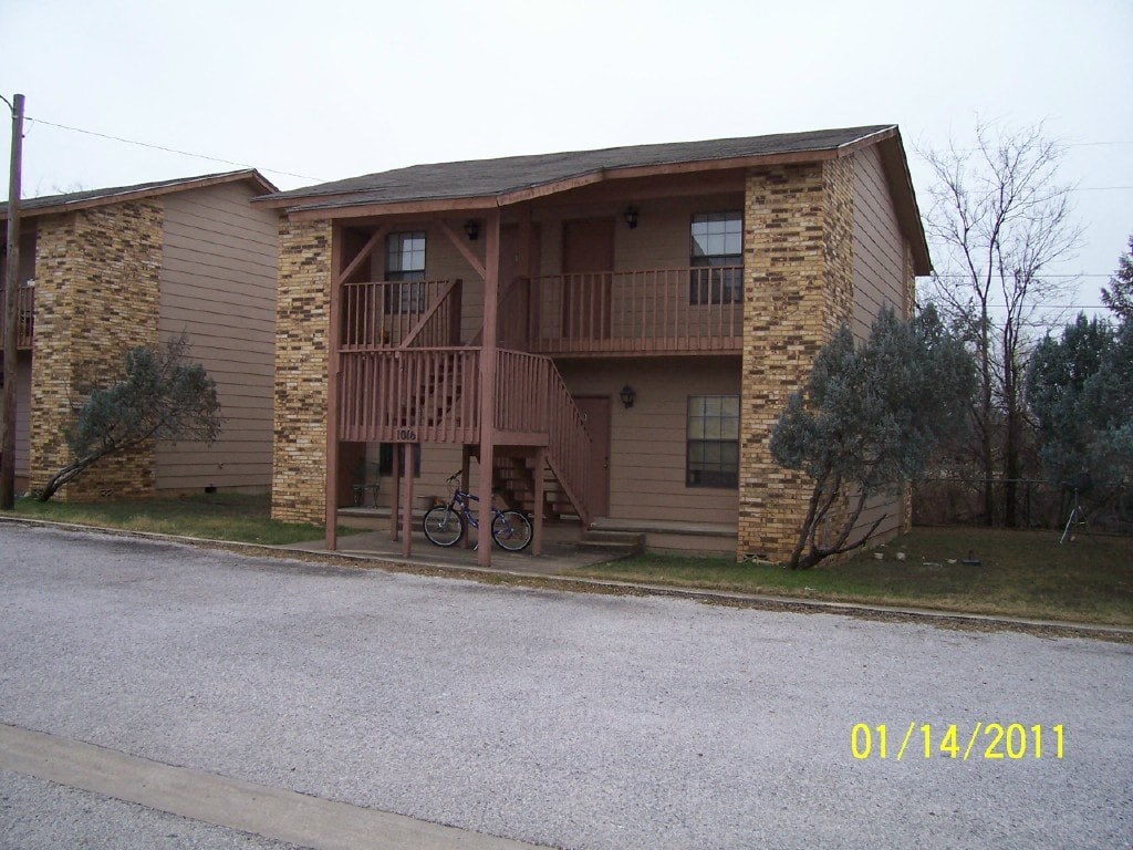 an apartment building with a bike parked in front of it