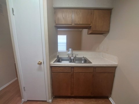 A small kitchen with a sink and cabinets.