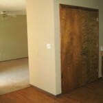 an empty room with a wooden door