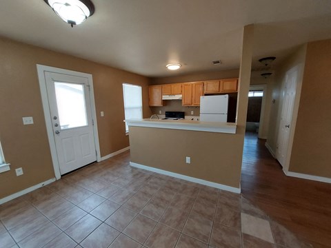 A kitchen area with brown walls and a white door.