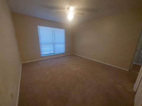 A room with a window and a light on.