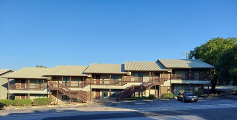 A large building with a parking lot in front.