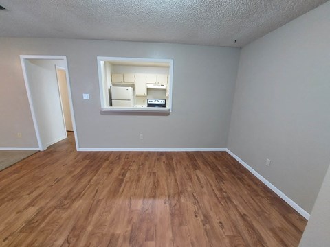 a living room with wood floors and a window