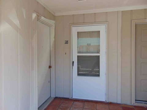 a white door with a window in a room