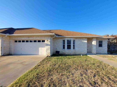 A house with a brown roof and a garage door.