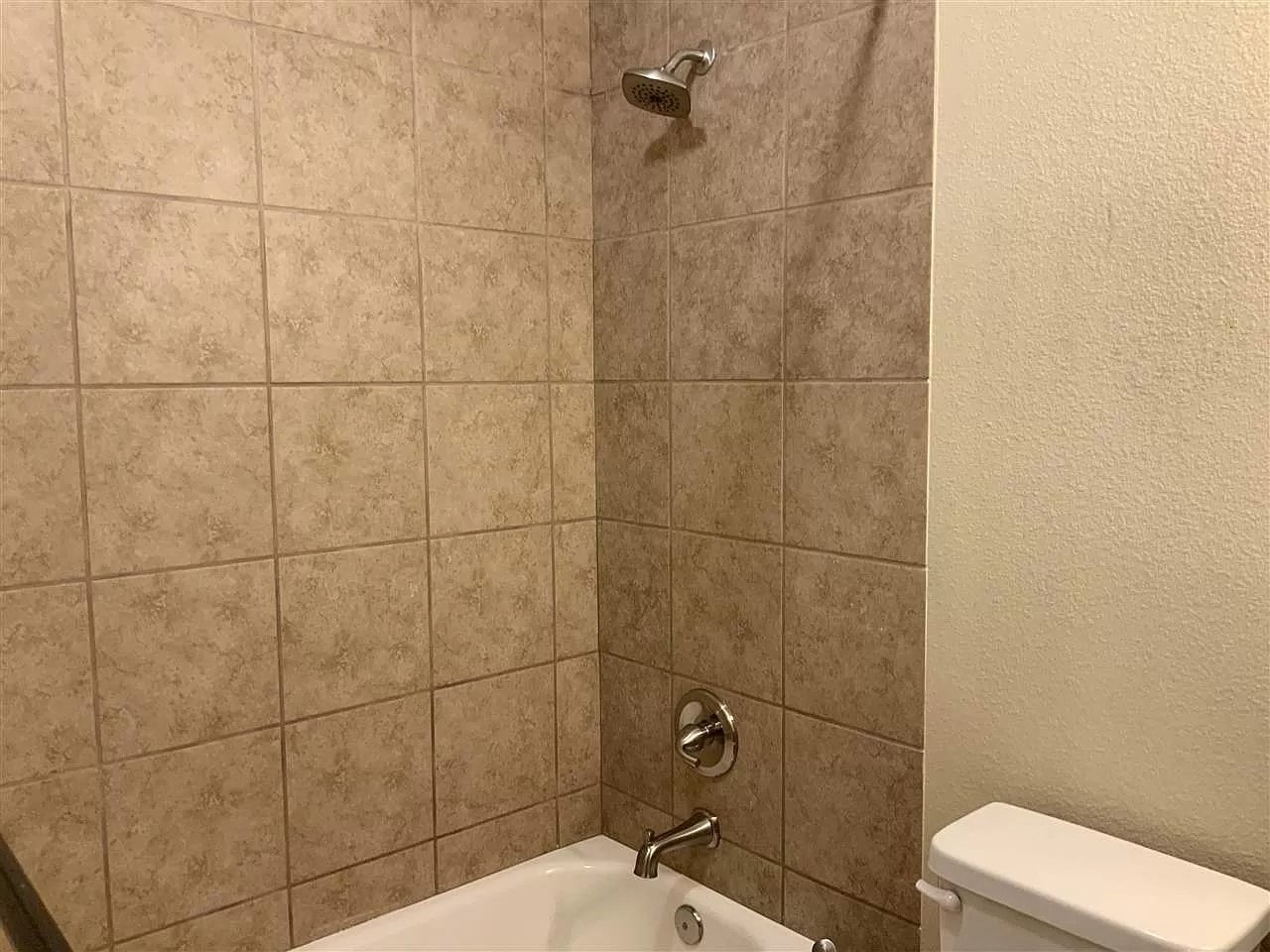 a bathroom with a shower and a toilet in it