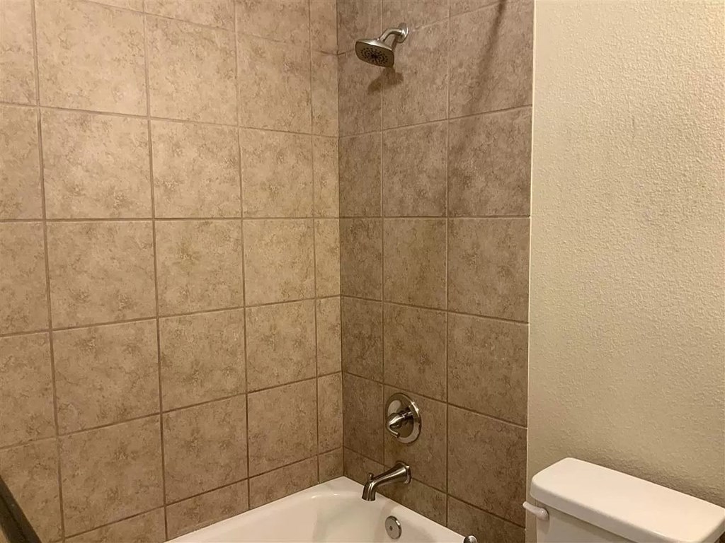 a bathroom with a shower and a toilet in it