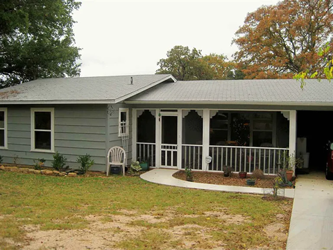 A house with a grey roof and a white porch.