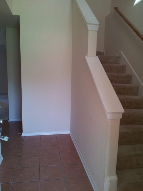 stairs in a home with white walls and a tiled floor