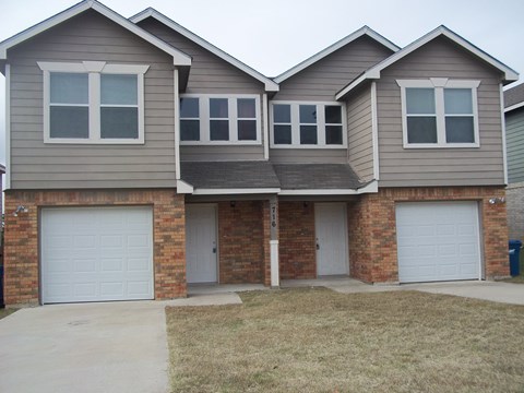 A two-story house with a garage on the first floor.