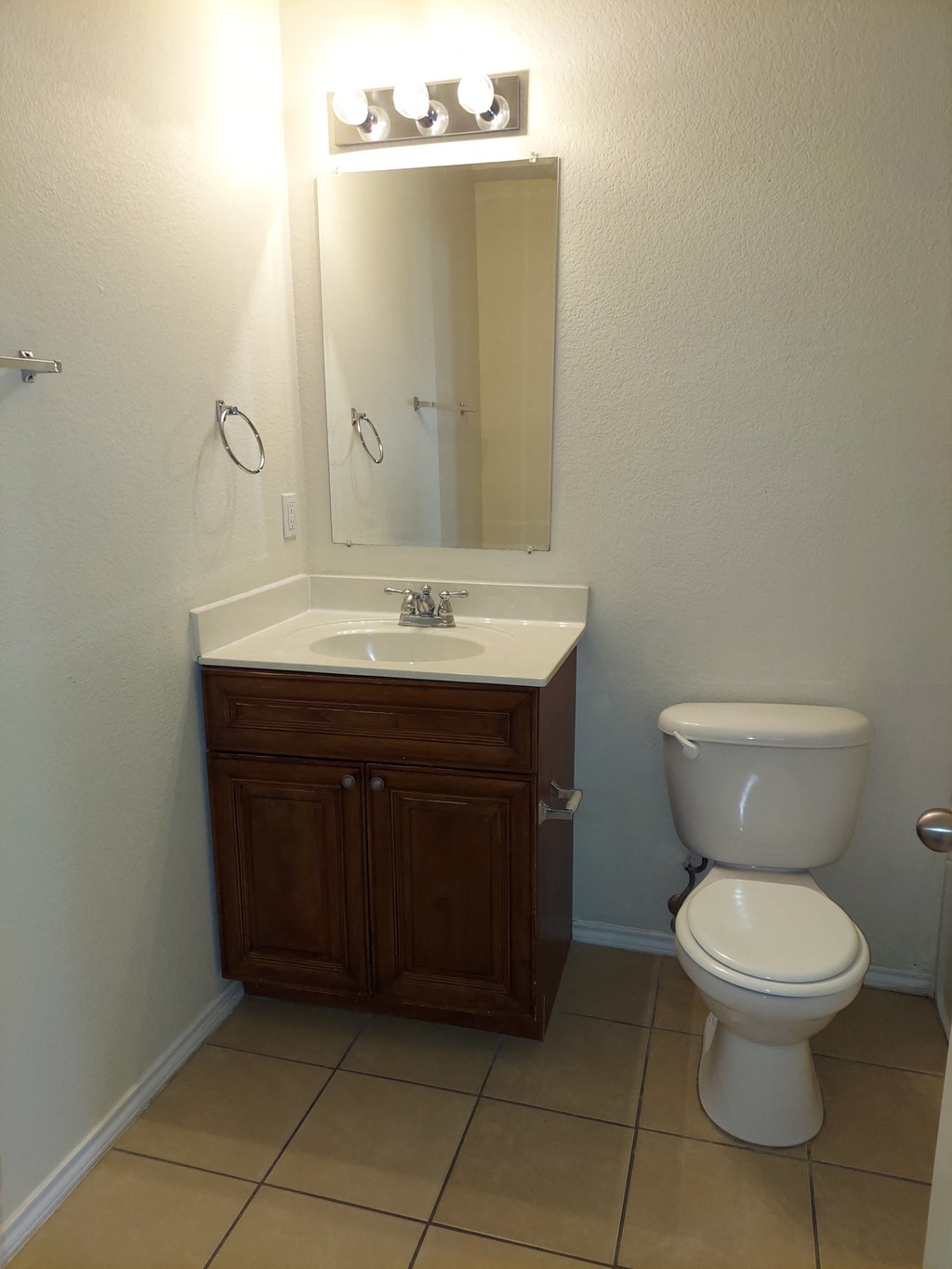 a bathroom with a toilet sink and a mirror