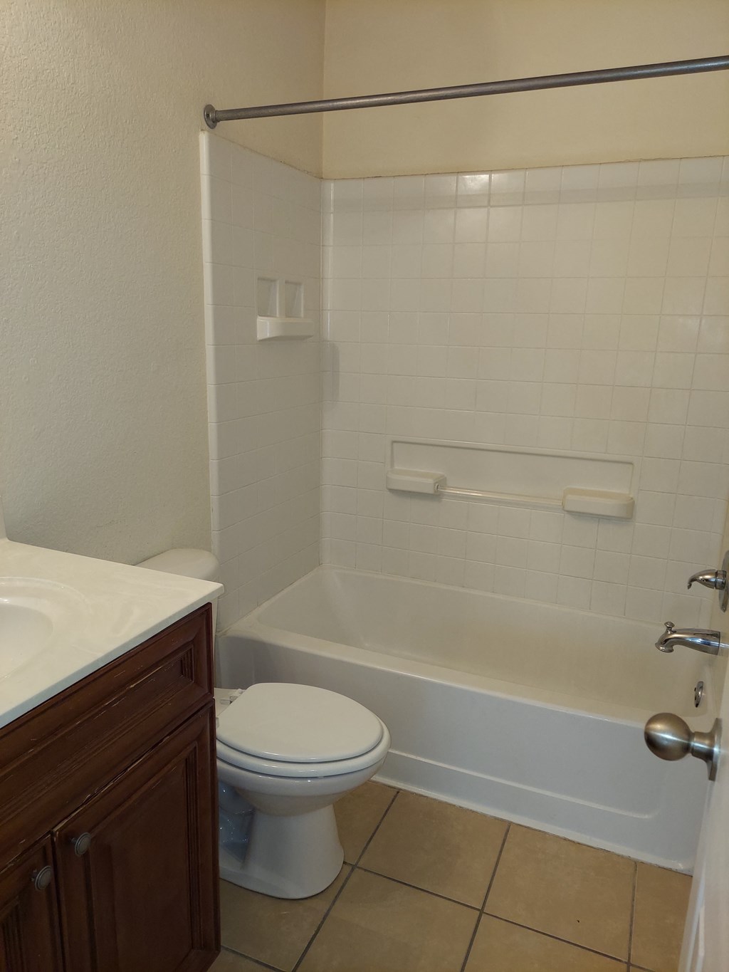 a bathroom with a toilet and a tub and a sink