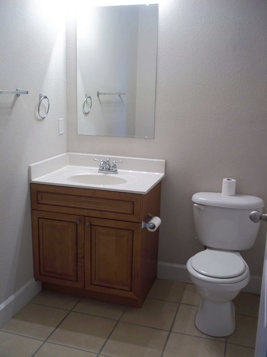 a small bathroom with a toilet sink and mirror