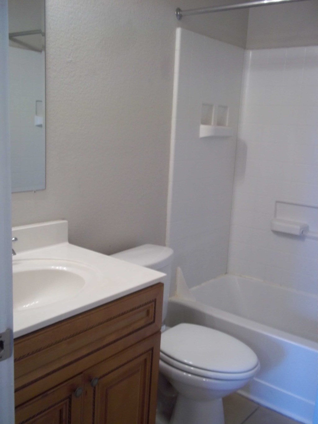 a bathroom with a toilet and a sink and a tub