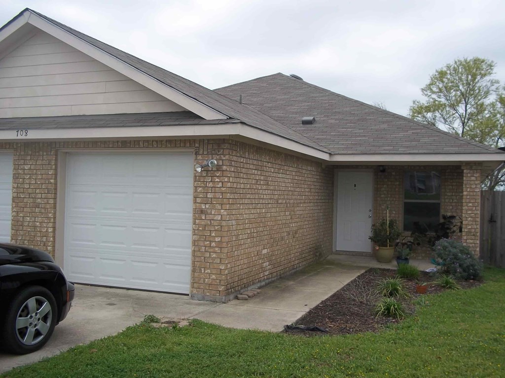 a brick house with a white garage door