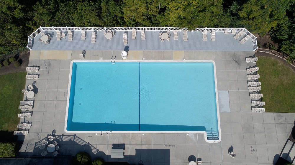 an aerial view of a swimming pool on top of a roof