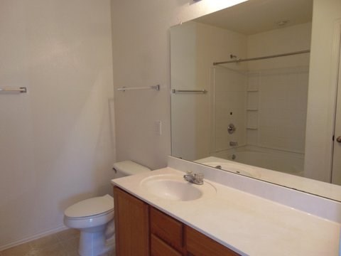 a bathroom with a sink toilet and a mirror