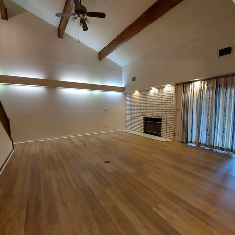 A room with wooden floors and a fireplace.