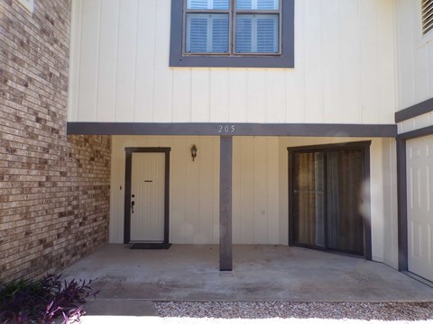 A house numbered 205 with a white garage door.