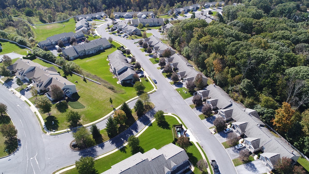 an aerial view of a neighborhood with houses and trees
