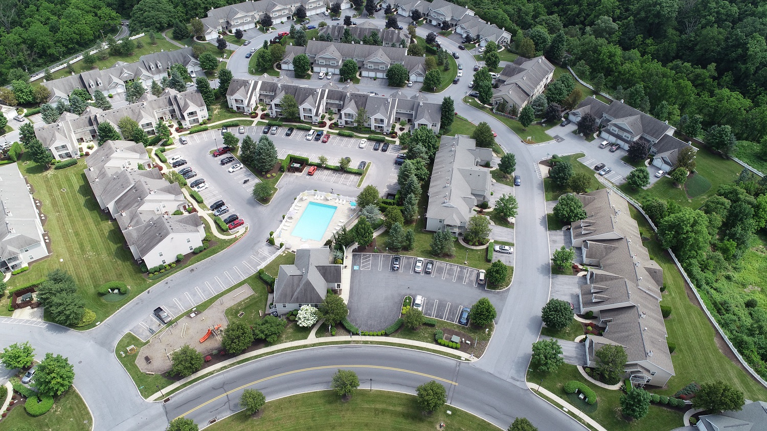 an aerial view of a neighborhood with houses and a swimming pool