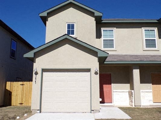 a white house with a white garage door