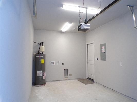 an empty room with a water heater and a door