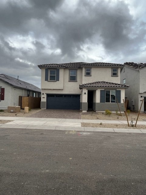 a house with a driveway and a cloudy sky