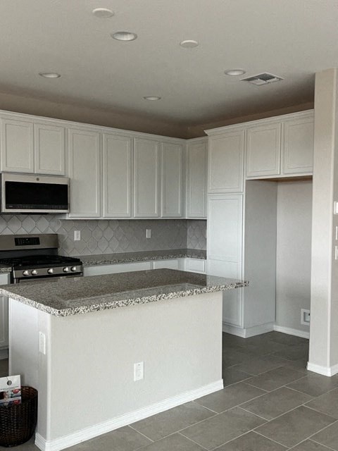a kitchen with white cabinets and a counter top