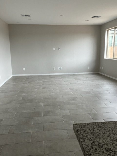 a empty living room with a tile floor