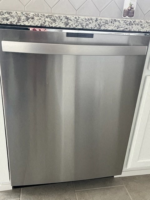 a stainless steel dishwasher sitting in a kitchen