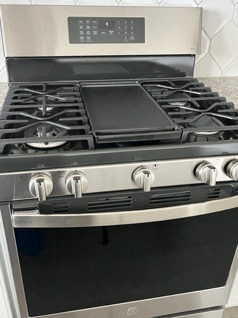 a black and silver stove top oven in a kitchen