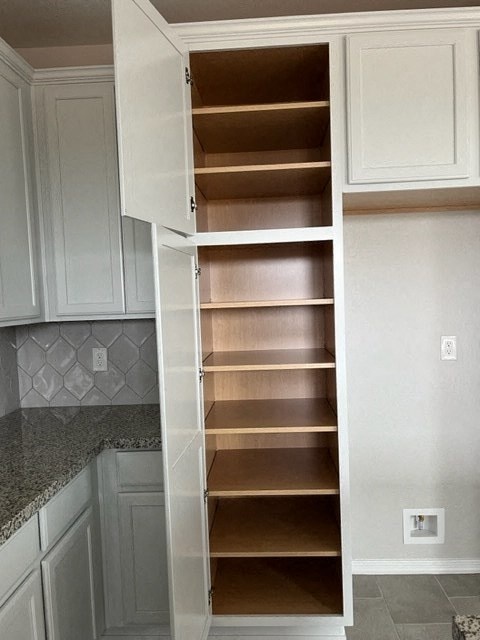 a white pantry with empty shelves in a kitchen