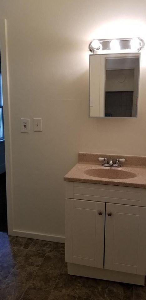 a bathroom with a sink and a mirror
