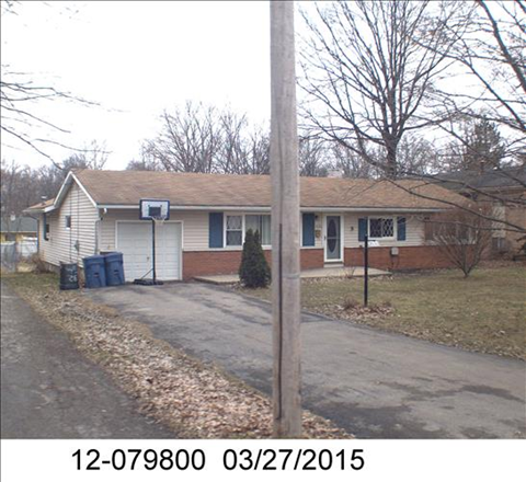 the front of a house with a street and a driveway