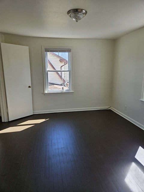 A room with a window and a door.