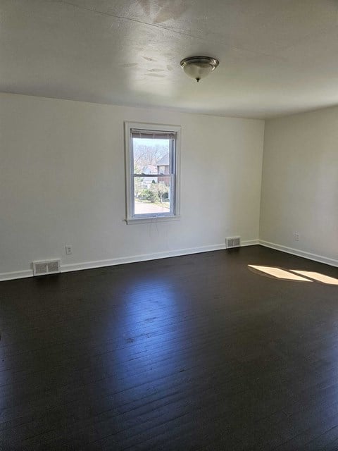 A room with a window and a ceiling fan.