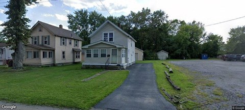two houses on the side of a road