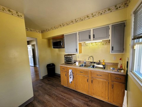 A kitchen with wooden cabinets and a sink.