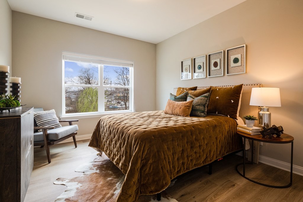 a bedroom with a bed and a window