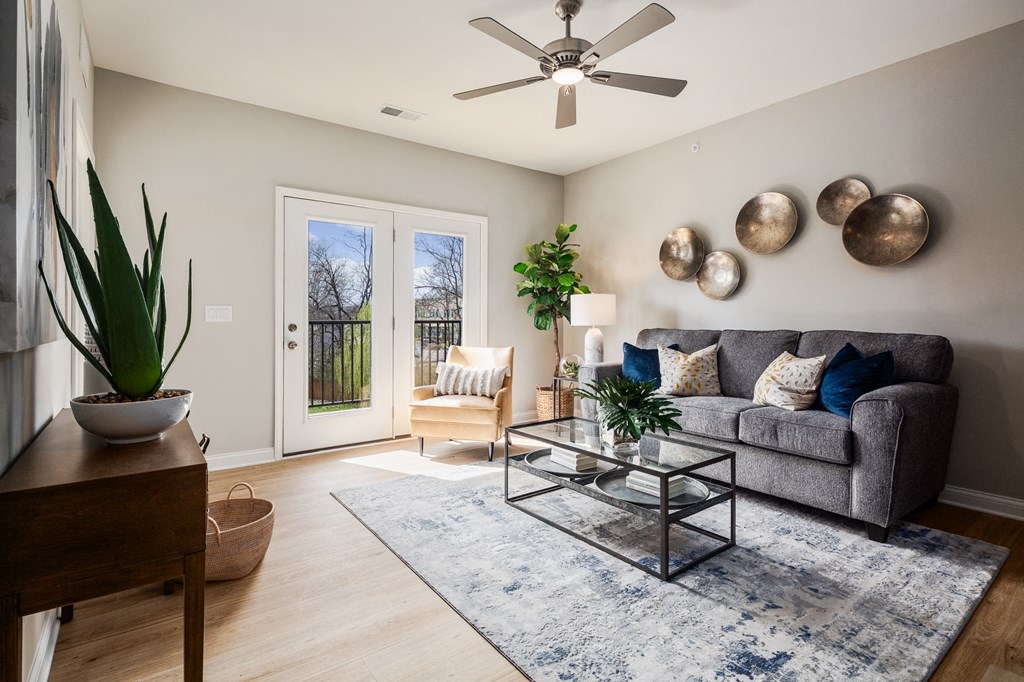 a living room with a couch and a ceiling fan