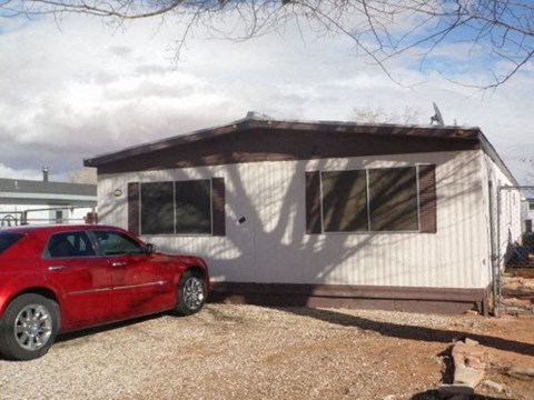 a house with a red car parked in front of it