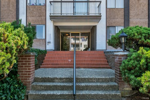 A building with a red brick staircase leading to the entrance.