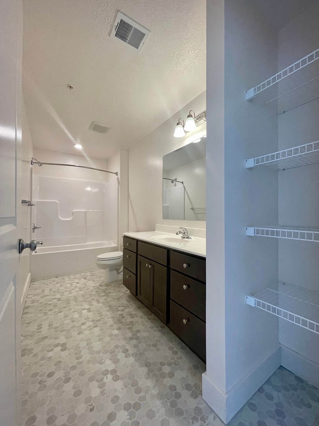 a bathroom with a sink and a shower and a toilet