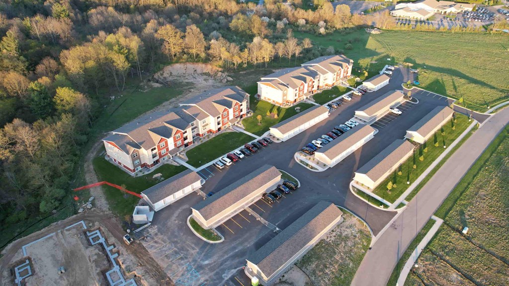 an aerial view of a parking lot and houses