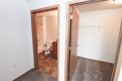 two views of a bathroom with a shower and a toilet